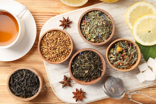 Preview: Concept of cooking tea with different types of tea on wooden background