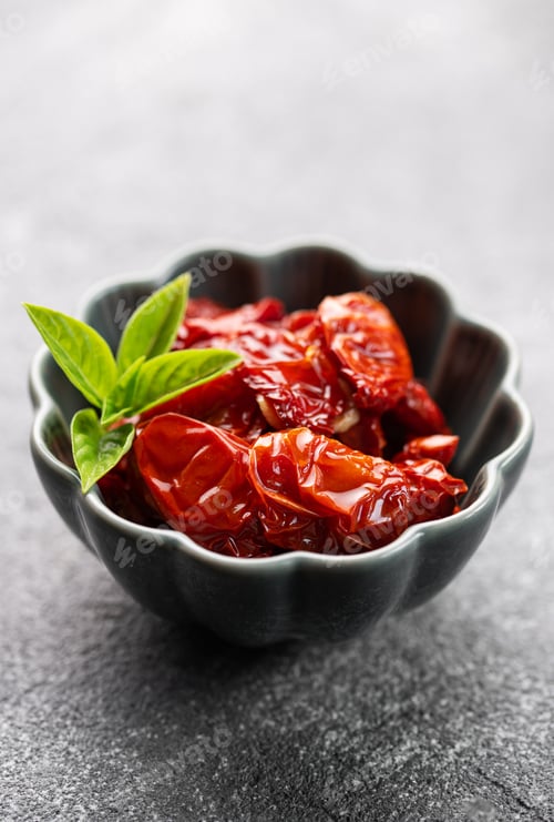 Preview: Bowl with sun dried tomatoes with fresh herbs and spices.