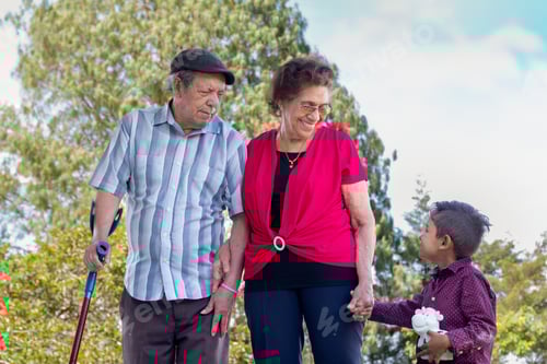 Preview: Happy elderly couple holding hands with their great grandchild.