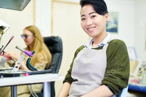 Preview: Smiling Asian Artist in Workshop