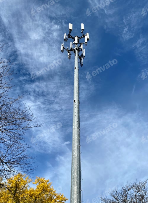 Preview: Tranquil scenery of a cell phone tower in a suburban neighborhood on a cloudy sky