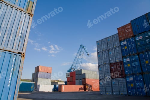 Preview: Stacked containers , crane in background