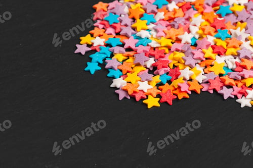 Preview: Colored star shaped candy sugar sprinkles as a background