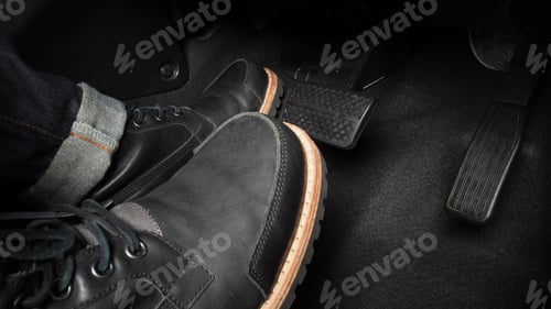 Preview: Close up the foot pressing foot pedal of a car to drive. Accelerator and brake