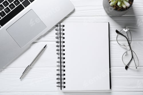 Preview: Pen, open notebook, glasses, floral decor and laptop on white wooden table, flat lay