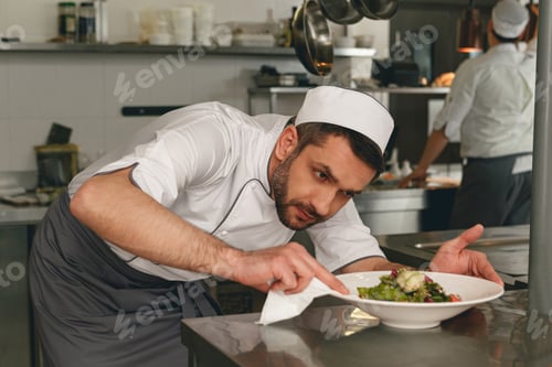Preview: Chef preparing salad in the modern kitchen of restaurant. Tasty and healthy food