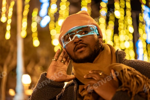 Preview: African man listening while using smart glasses in the city