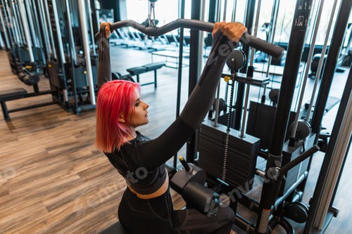 Preview: Healthy beautiful young fitness model woman working out in the gym