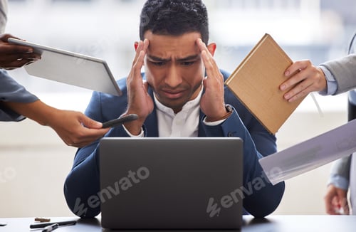 Vista previa: Shot of a businessman looking overwhelmed in a demanding office environment