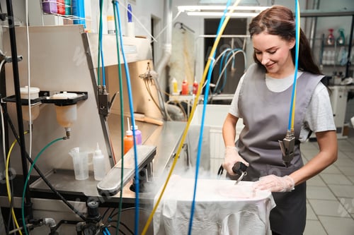 Preview: Smiling woman using steam gun and easily removing dirt and stains from clothes