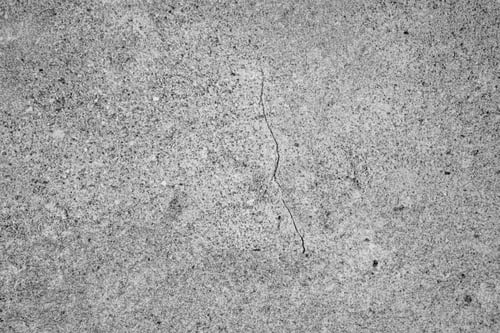 Preview: Rough gray concrete texture background with natural grain pattern and subtle surface cracks