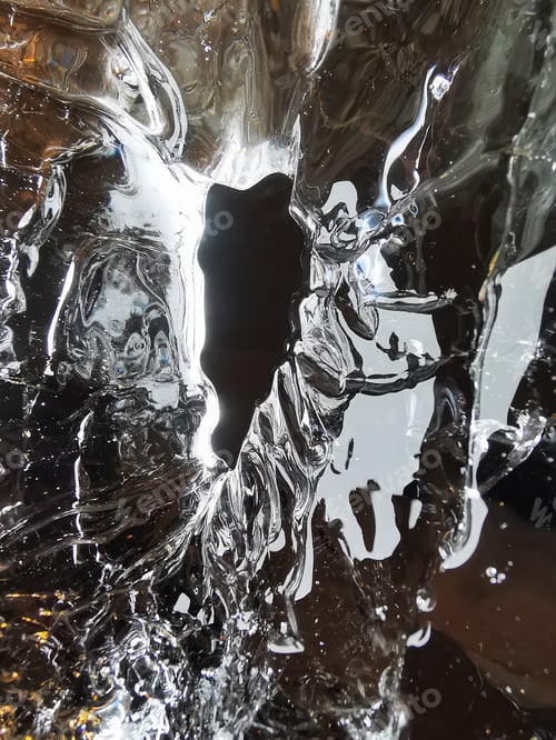 Preview: Vertical shot of a melting ice with a small hole in the middle