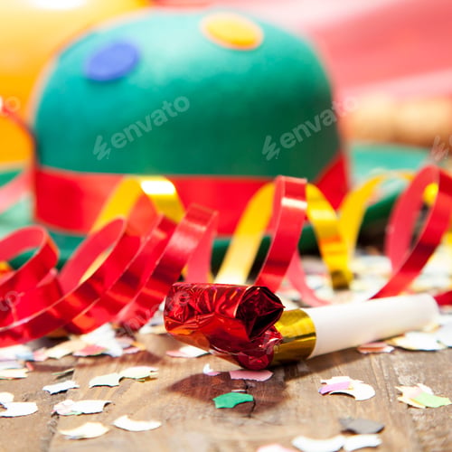 Preview: Closeup of party decorations and a green hat on the floor under the lights