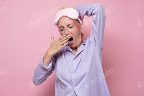 Preview: Yawning tired caucasian woman with sleeping mask