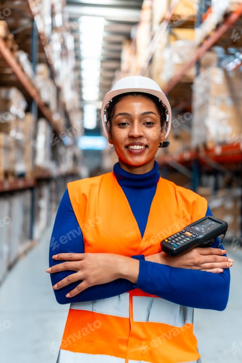Preview: Female logistics worker smiling in distribution warehouse