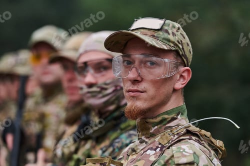 Preview: Soldier fighters standing together with guns. Group portrait of US army elite members, private