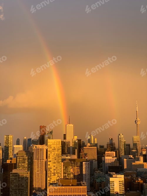 Preview: Vertical shot of buildings after rain with a rainbow in Toronto, Canada