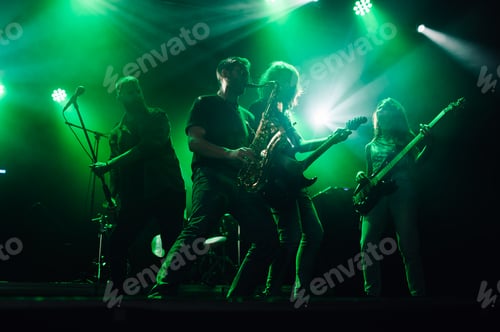 Preview: Rock band performing live on stage with green lighting
