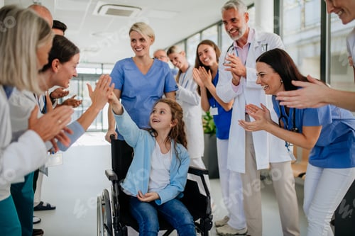 Preview: Medical staff clapping to little girl patient who recovered from serious illness.