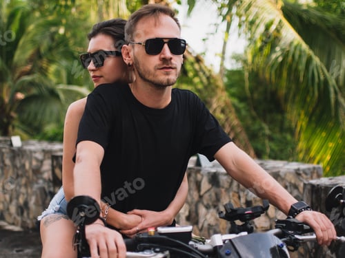 Preview: Couple Embracing on a Motorcycle in Tropical Setting