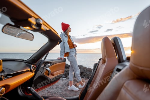 Preview: Woman traveling by car on the rocky ocean coast