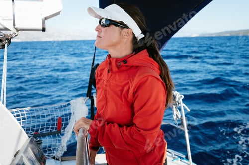Preview: Attractive strong woman sailing with her boat