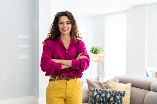 Preview: Beautiful young woman with colorful attire at home