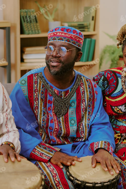 Preview: Middle Aged Black Man Playing Drum during Kwanzaa Celebration Indoors