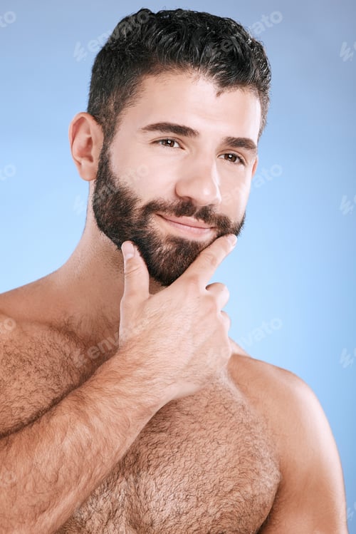 Preview: Idea, beauty and skincare with a man model in studio on a blue background for natural wellness or g