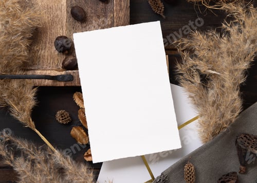 Preview: Vertical card on wooden tray near brown decor and pampas grass top view, boho mockup