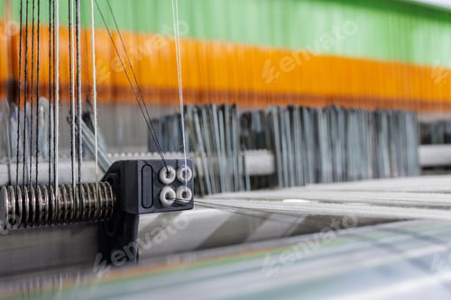 Preview: Wool warp tensioner on modern weaving machine macro in textile manufacturing