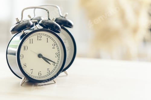 Preview: Morning sun. Alarm clock on a beautiful background