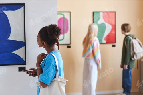 Preview: Colorful shot of diverse group of teenagers looking at art