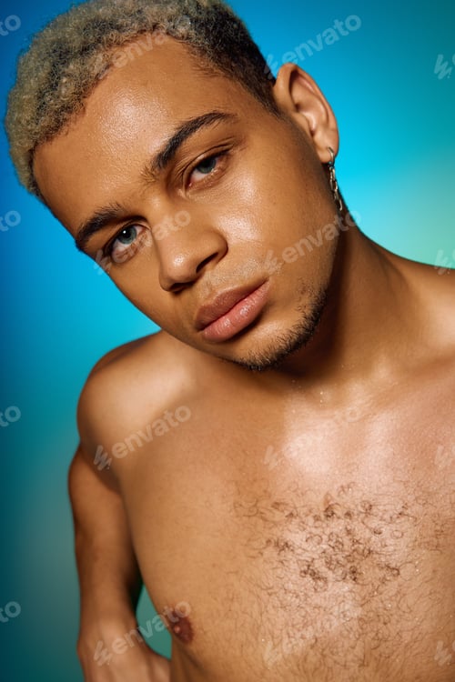 Preview: Young man with dyed hair showcases individuality in artistic studio setting