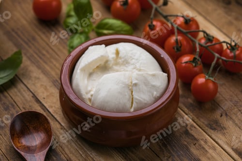 Preview: Burrata cheese with tomatoes on wooden board