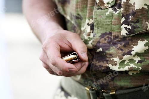 Preview: Soldier holding a loaded handgun magazine