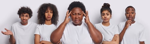 Preview: African woman keeps hands on temples suffers from migraine stands in centre have thoughtful
