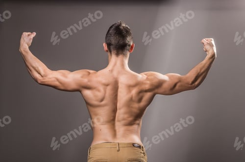 Preview: Rear View, Back Muscles Bodybuilder, Young Adult Man Posing, Arms Hands Outstretched.