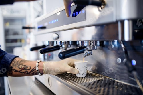 Preview: Barista working with gloves, coffee shop open after lockdown quarantine