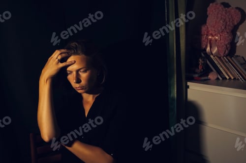 Preview: Portrait of a young sad woman in depression, stress. Mental health.Dark key