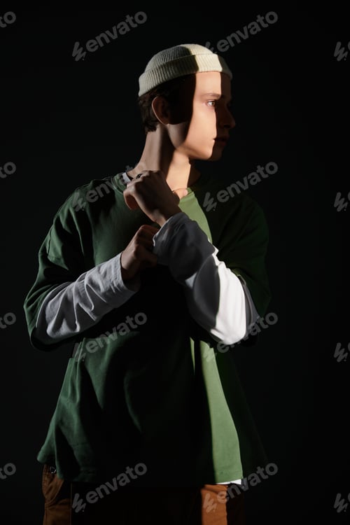 Preview: Stylish teenager expresses youth culture in a striking shadowy portrait