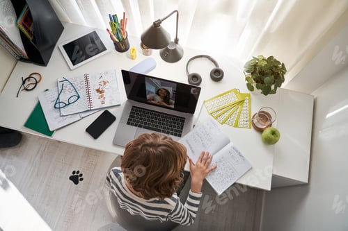 Preview: Boy doing homework during video call