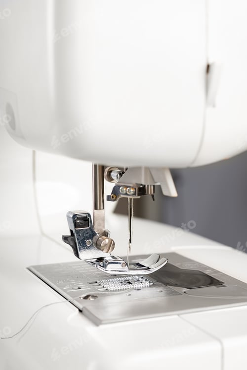 Preview: Modern white sewing machine presser foot closeup, macro