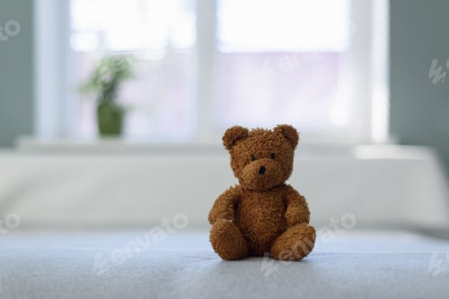 Preview: Plush teddy bear toy on white bed