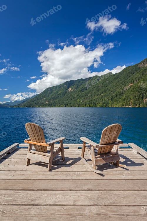 Preview: Two Adirondack chairs rest on a wooden dock with views of Lake Crescent