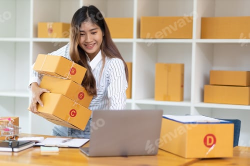 Preview: Startup SME small business entrepreneur freelance Asian woman using laptop and review orders online