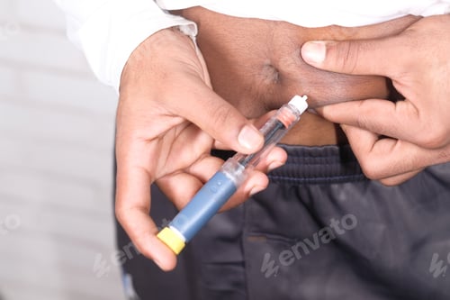 Preview: young man hand using insulin pen close up