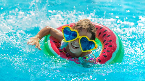 Preview: The child in the pool swims in a circle. Selective focus.