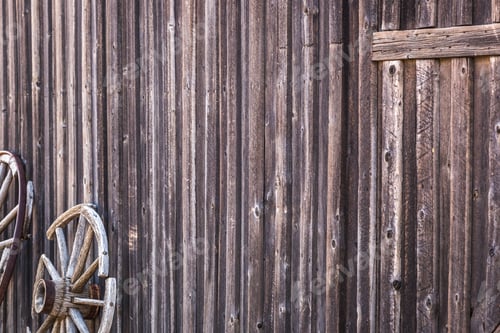 Preview: Abstract of Vintage Antique Log Cabin Wall and Wagon Wheel.