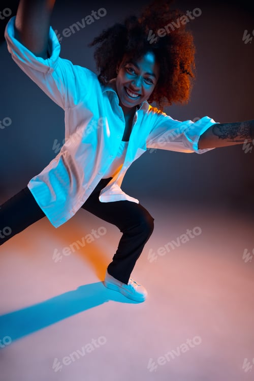 Preview: Full-length portrait of African young girl casual clothes, outfit isolated on dark blue studio
